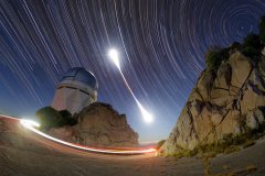 This still image combines hundreds of time-lapse exposures that capture the entirety of the 8 November 2022 total lunar eclipse above the Nicholas U. Mayall 4-meter Telescope at Kitt Peak National Observatory, a Program of NSF’s NOIRLab. Lunar eclipses occur when the Moon passes through the shadow of Earth. During a total lunar eclipse, when the whole Moon enters Earth’s shadow, our natural satellite is drenched in red. The period of totality is evident in this image by the red at the center of the luna